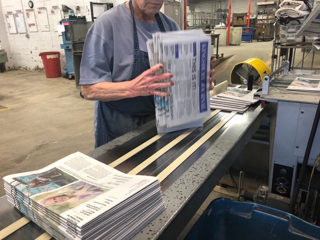 Hot off the presses, the papers are being bundled for delivery to the Post Office, and then off to subscribers' mailboxes.