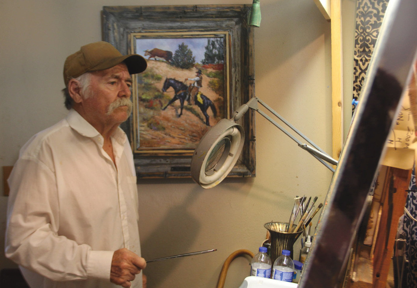 Mary Lee received third place for Best Portrait Photo in the state newspaper contest for this shot of Galen Wallum at his easel after recovering from a mosquito bite. Judges commented "this view captures a personality and is almost Rockwell-esque."