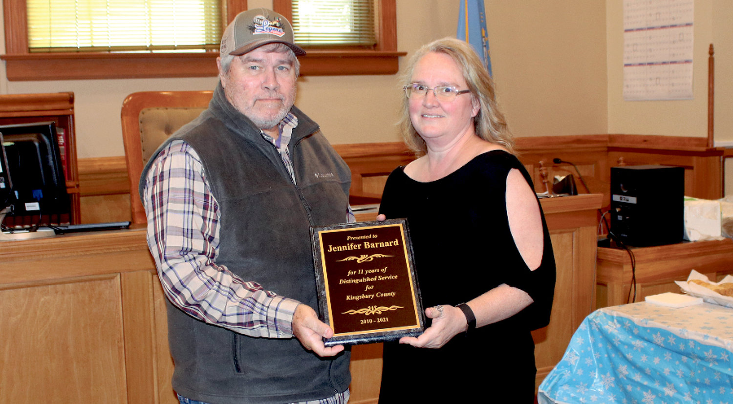 KIngsbury County Commission Chair Roger Walls presents Jennifer Barnard with a plaque for her 11 years of service as a county employee, most recently as Kingsbury County Auditor.