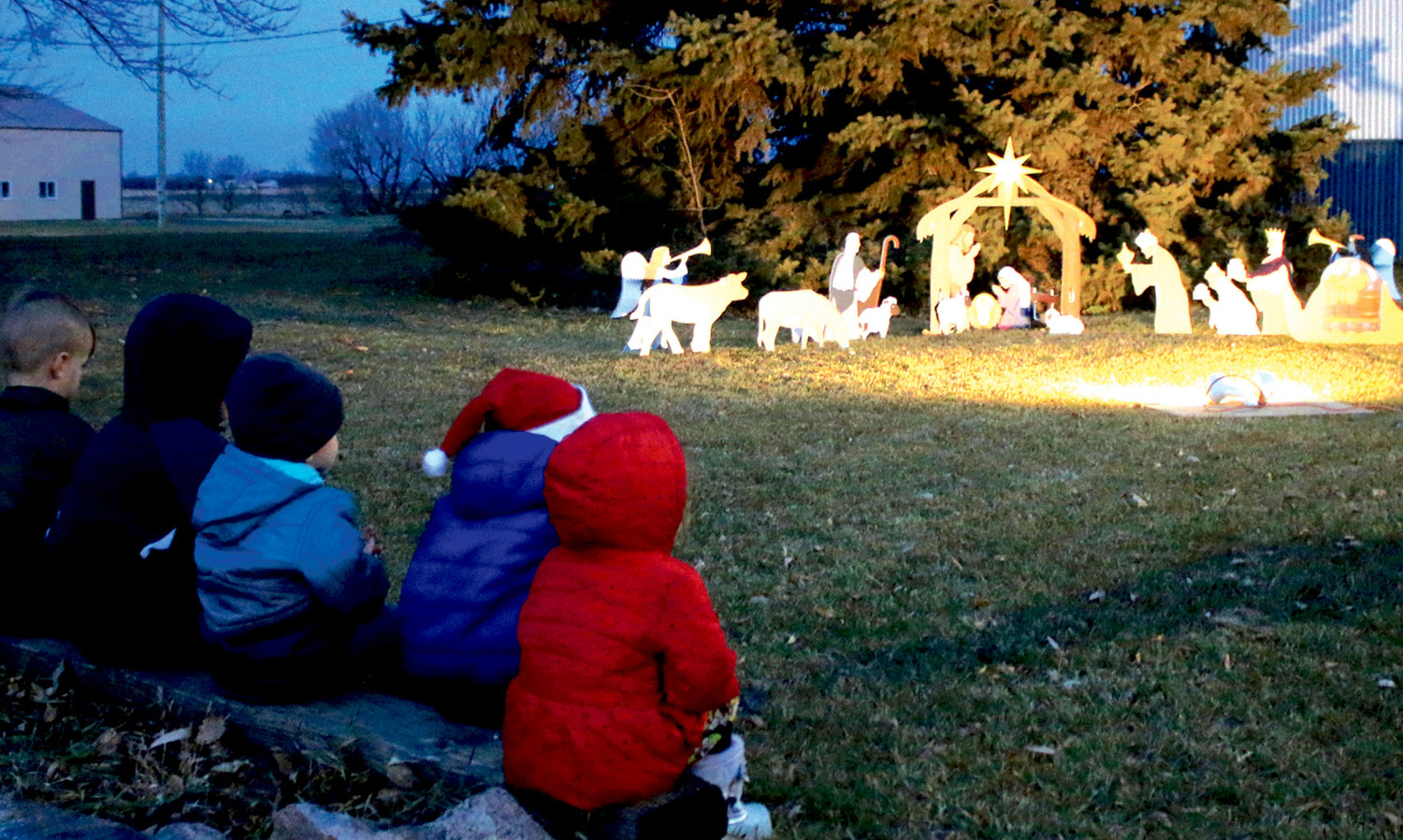 On Sunday evening at sunset in Oldham, residents and children gathered to see the Lighting of the Nativity. The lighting has been a tradition for close to thirty years. Once the Nativity was lit, the crowd sang “Away in a Manger” and other songs. The group moved to the high school gym and had a barbeque supper, games including BINGO and other Christmas activities.