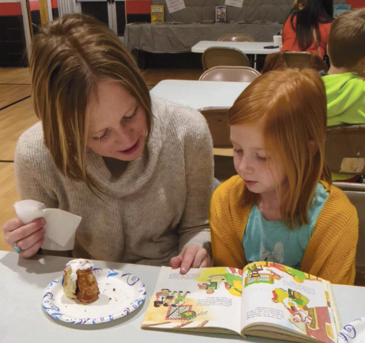 Sara Newman and daughter Addison read a book together. 
