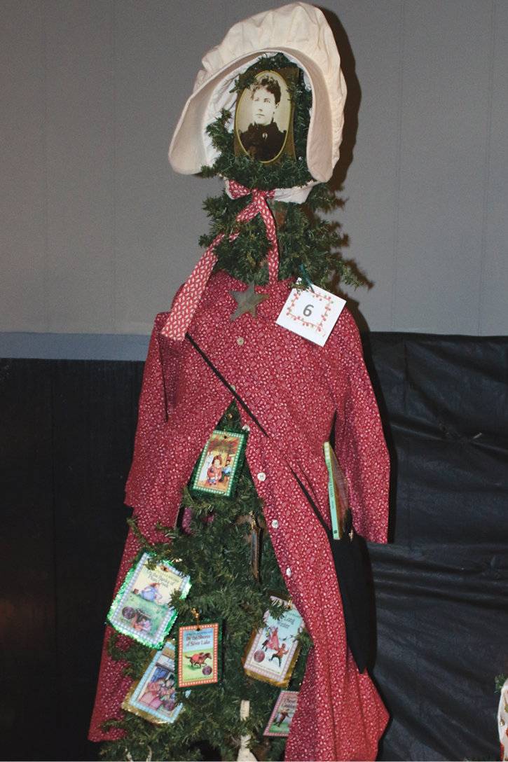 2nd place silliest went to the LIW Memorial Society and a “Little House” theme. The tree was topped with a sun bonnet, two stockings hung from the lower branches and a prairie dress adorned the upper branches. Covers of the “Little House” books were hung.