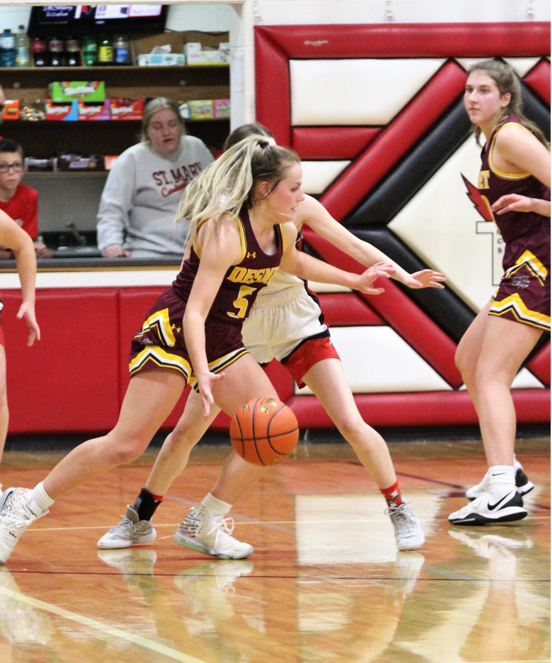 Emma Albrecht (5) handles the ball while Kennadi Buchholz posts up inside Mon., Dec. 20 against Dell Rapids St. Mary. The Bulldogs defeated the Cardinals 54-43 to extend their record to 5-0.