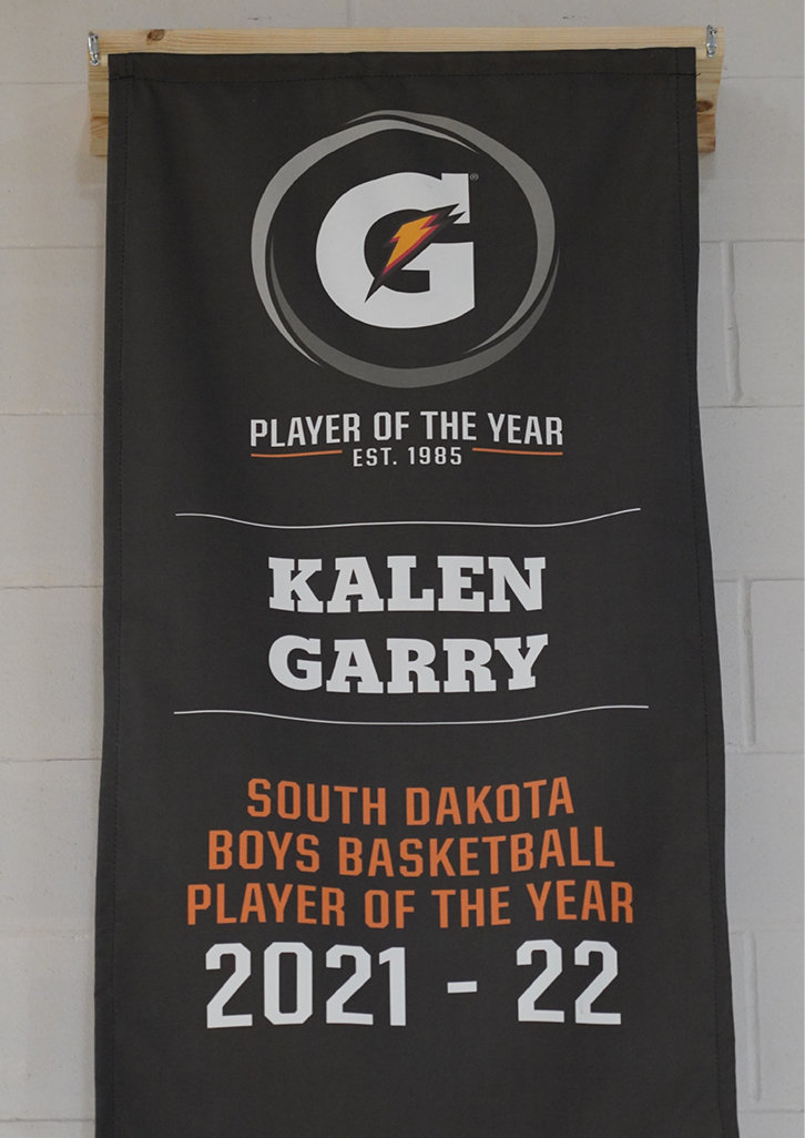 A new banner hangs on the north wall in the Dog Pound at De Smet High School. Kalen Garry’s 2021-2022 Gatorade’s South Dakota Boys Basketball Player of the Year earned him the privilege to name a local organization as a recipient of a $1,000 award. Garry chose the De Smet Community Foundation and the weight room. Garry feels the weight room was an asset to his basketball career and hopes to see it assist other De Smet athletes.