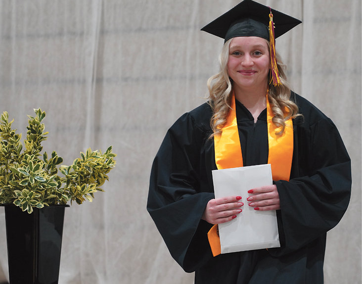 Riley Myers exits the stage after receiving her diploma just seconds before. Myers plans to pursue a career as a medical laboratory technician.