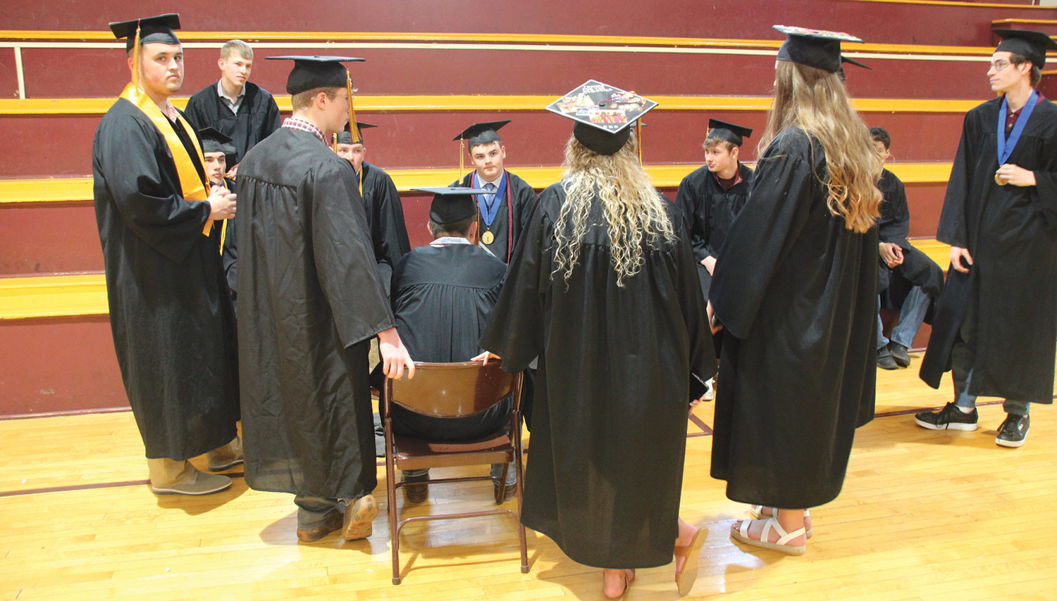 Students gather for a few last minutes together before the graduation ceremony Saturday, May 7.