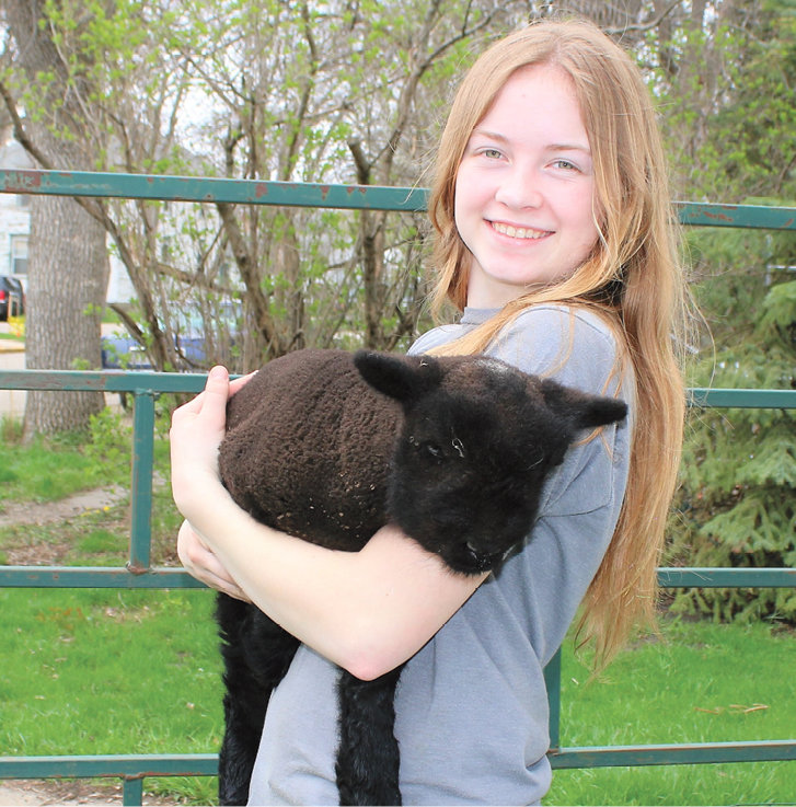 Gretta Larson and one of her lambs.
