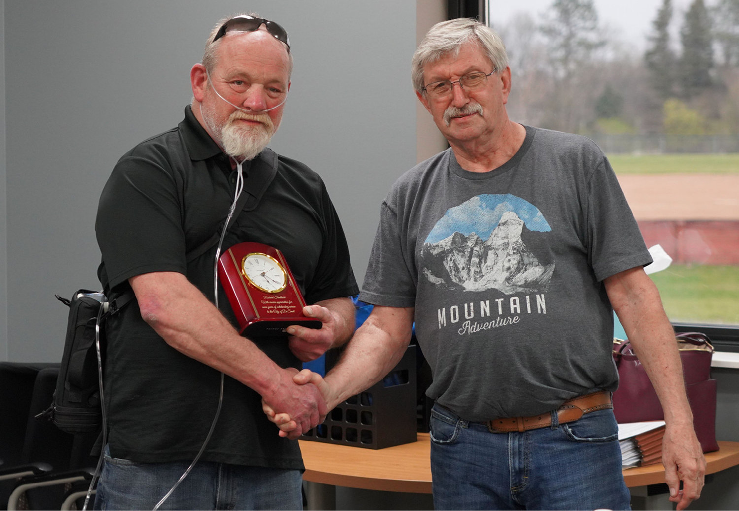 Richard Stoddard, left, was presented with a clock from De Smet Mayor Gary Wolkow at the council meeting Wednesday. Stoddard had been employed with the City of De Smet for seven years and was the water and wastewater superintendent when he retired.