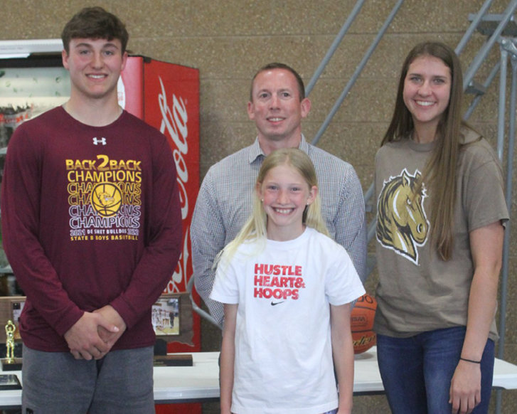 Kalen Garry, left, and Kennadi Buchholz, right, male and female Athlete of the Year and recipients of the Mollner Athletic Scholarship, stand next to George Mollner and daughter Hailey Mollner.