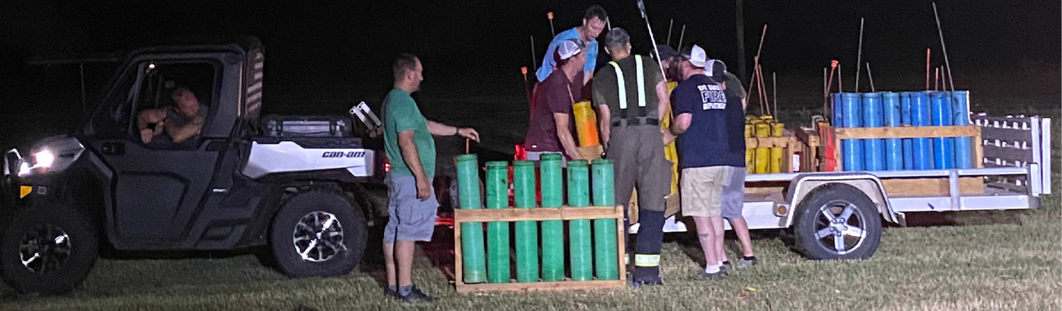 After the fireworks display, the work isn’t over for the firemen. Still sweating from wearing their bunker gear, they are out in the mosquitoes and heat, putting things away and cleaning up the mess.