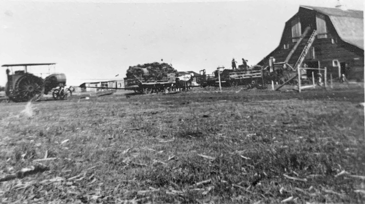 Pictured is the site of Sana in the 1880’s. This picture is of the Lorenz brothers threshing for Les Clendening. They were blowing straw into the haymow and elevating grain into the barn at the same time. The tractor is a Twin Cities Tractor. Picture taken in 1927-1928.
