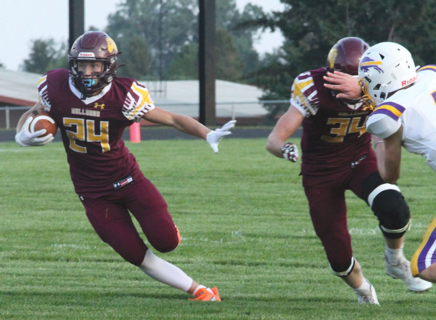 De Smet's Kadyn Fast (24) cuts inside a block by teammate Tucker Anderson (34) enroute to a 36-7 Bulldog victory over the Stanley County Buffalos Friday night at Wilkinson Field in De Smet.